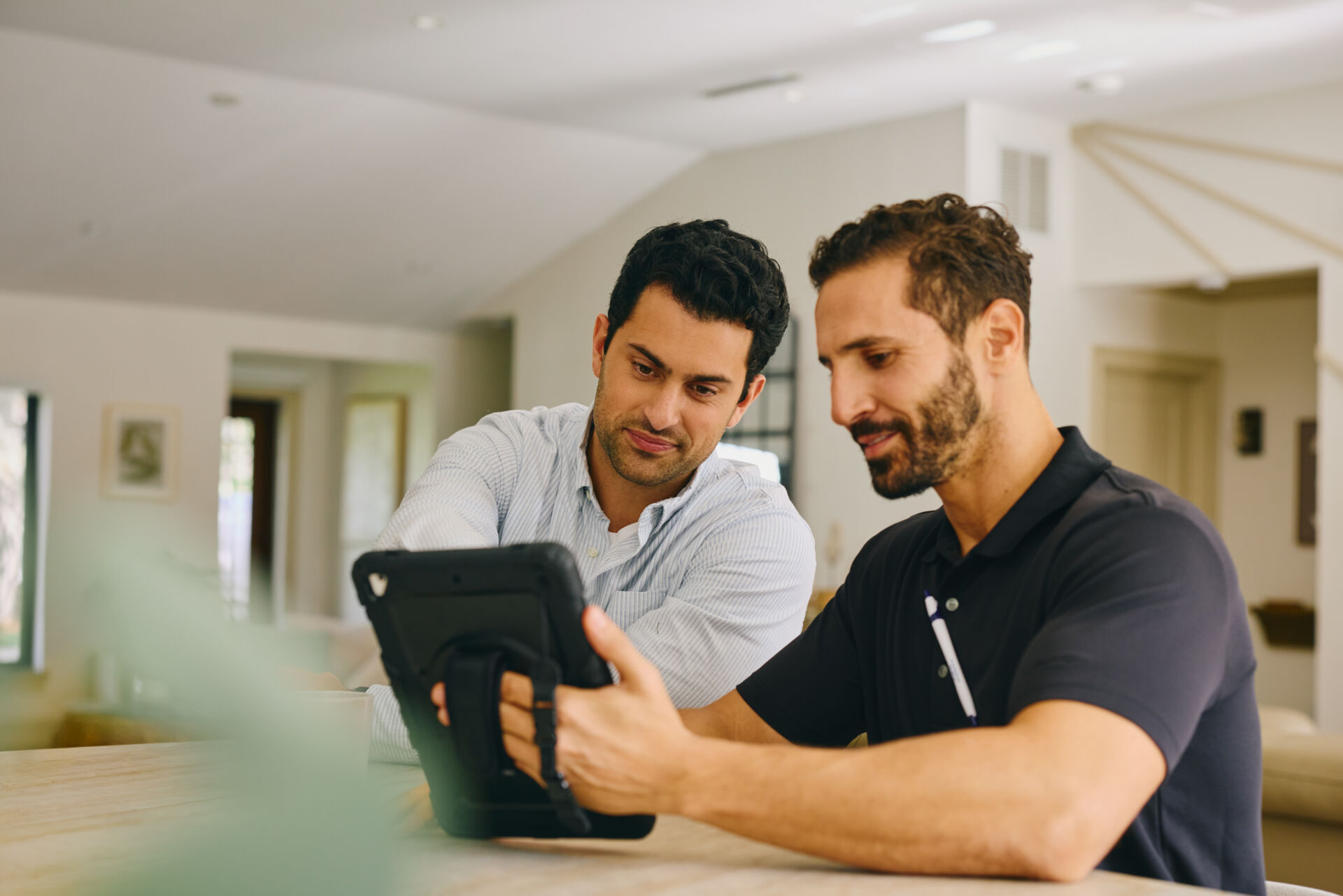 Two men using a tablet