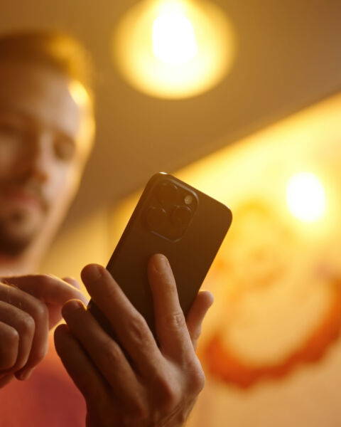 Person reviewing multi-site security performance on a phone