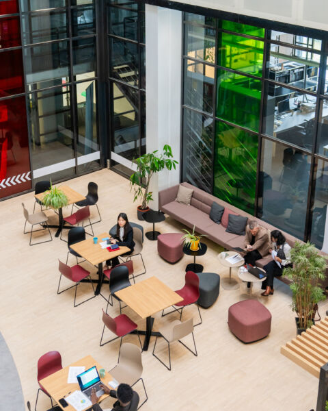 Large space with tables and people sitting at the tables