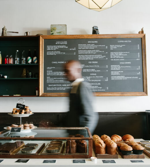 Employee working behind the counter of a small bakery