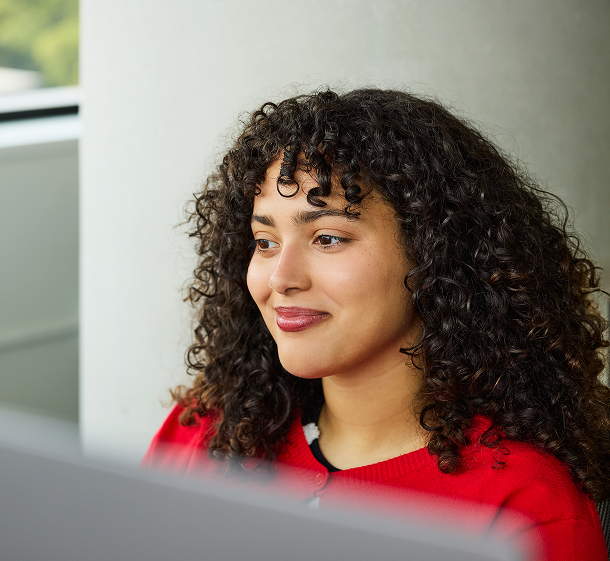 Employee at a desk opening a scheduled report delivered by email
