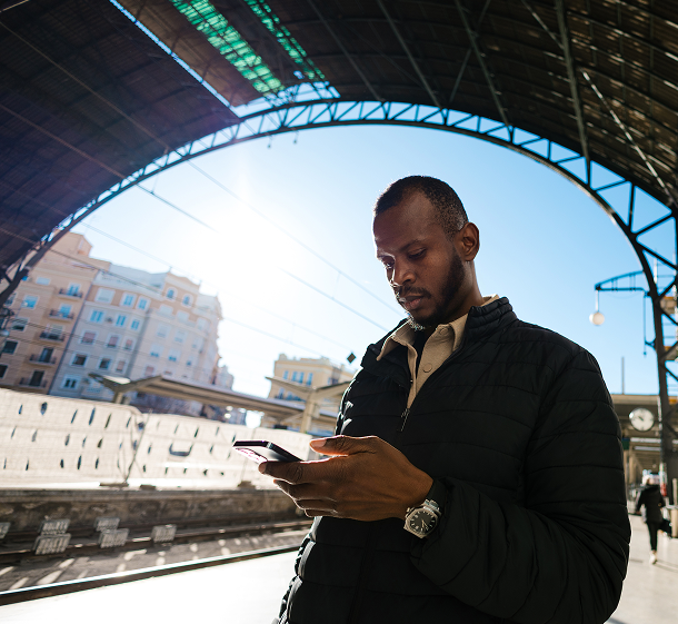 Manager using a phone outside a commercial building to check camera connectivity and recording status
