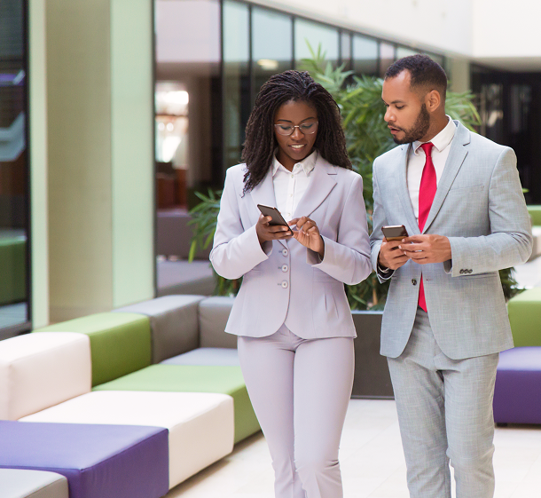 Two people talking and holding phones