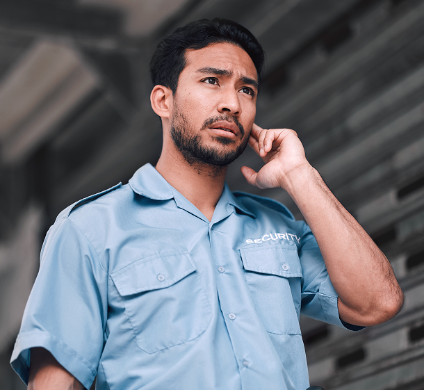 Man standing and holding his ear