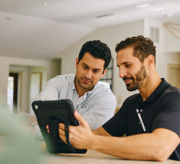 Two men using a tablet
