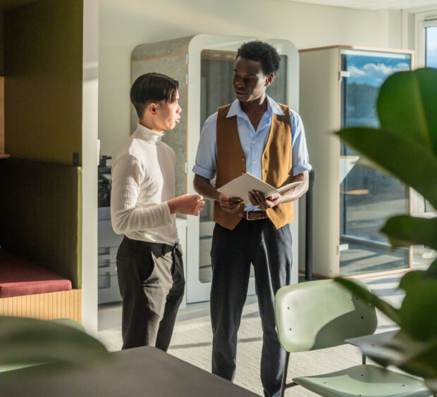 Two managers reviewing operations reports while walking through a commercial facility