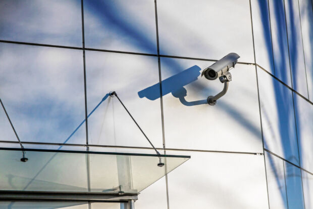 Existing commercial security camera mounted on a building exterior, upgraded with cloud management