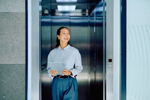 Systems administrator standing in a server room managing user permissions across sites